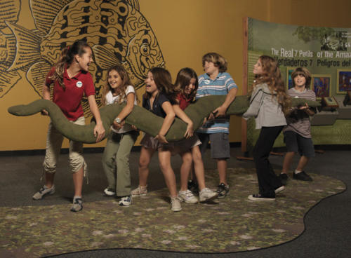 Kids enjoying lifting the life-sized anaconda built by Gary Staab